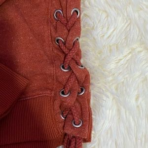 Rust orange thin sweater with thick ties on sides